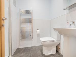 a white bathroom with a toilet and a sink at 3 Bed in Threlkeld SZ217 in Threlkeld +5 photos