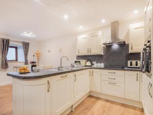 a kitchen with white cabinets and a sink at 3 Bed in Threlkeld SZ217 in Threlkeld