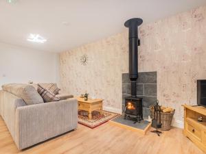 a living room with a couch and a fireplace at 3 Bed in Threlkeld SZ217 in Threlkeld