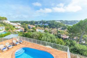 a pool on a deck with a view of a city at Villa Mirador B by Sonne Villas in Cala Galdana