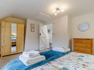 a bedroom with a bed with towels on it at 1 Bed in Stoke on Tern 85516 