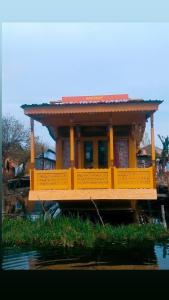 a house on a boat in the water at H.B Holiday home in Srinagar