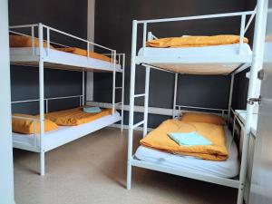 a room with three bunk beds in a room at Hostel B47 in Reykjavík