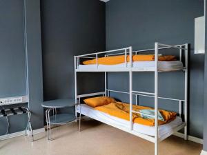 a bunk bed room with two bunk beds and a table at Hostel B47 in Reykjavík