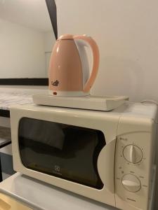 a tea pot sitting on top of a microwave at Asny Home in Chiang Mai