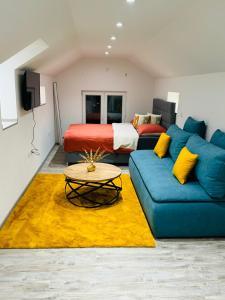 a living room with a couch and a bed at Studio apartman Cuprija in Cazin