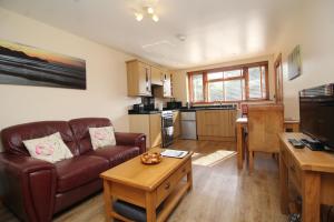 a living room with a couch and a table at Boardman's Lodge in Peterborough