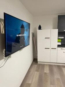 a living room with a flat screen tv on a wall at Monteurwohnung Kassel, 4 Personen in Niestetal