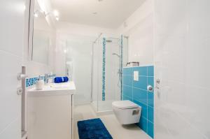 a white bathroom with a toilet and a shower at Studio apartment Stella in Labin