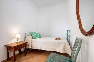 a bedroom with a bed and a table with a mirror at Apartamento la Solapa in Pájara