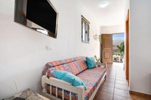 a living room with a couch and a flat screen tv at Apartamento la Solapa in Pájara