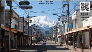 an empty street with a mountain in the background at 古民家再生ホテル　Relink in Fujiyoshida