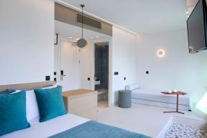 a bedroom with a bed and a bathroom at Twinn Downtown Piraeus, Santikos Collection in Piraeus