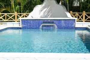 a pool with a slide in the middle of it at Green Door Oasis in Christ Church