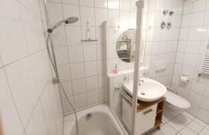 a white bathroom with a shower and a sink at Holiday apartment Sybille in Bad Kohlgrub in Bad Kohlgrub