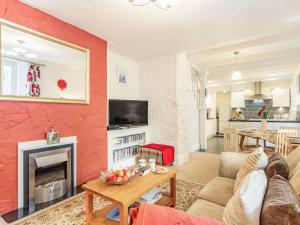 a living room with a red accent wall at 2 Bed in Brixham 86879 in Brixham