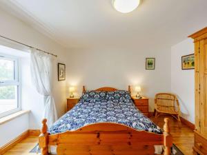 1 dormitorio con cama de madera y ventana en 2 bed in Appleby 87537, en Long Marton