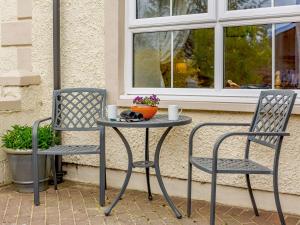 two chairs and a table on a patio at 2 bed in Appleby 87537 in Long Marton