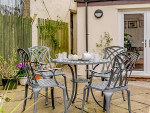 a table and four chairs on a patio at 2 bed in Appleby 87537 in Long Marton