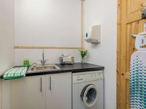 a kitchen with a sink and a washing machine at 2 Bed in Louth 86797 in Louth