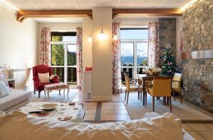 a living room with a christmas tree and a table at PRADOS DE VELARTA in Cerler