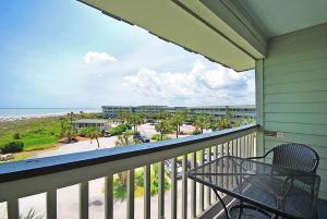 a balcony with a table and a view of the beach at 304A Sea Cabin in Isle of Palms