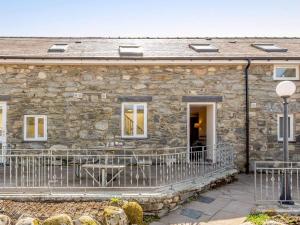 a stone house with a balcony in front of it at 2 bed property in Bala North Wales 87274 in Llandderfel