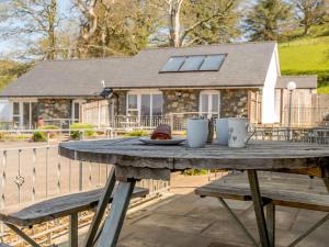 a wooden table with two mugs on top of it at 2 bed property in Bala North Wales 87274 in Llandderfel