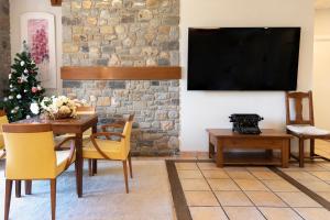 a living room with a table and a tv at PRADOS DE VELARTA in Cerler