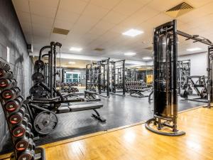 a gym with a lot of equipment in a room at 2 Bed in St. Mellion 87708 in St Mellion