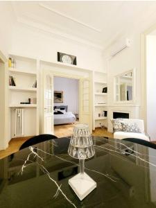 a living room with a glass table and a bedroom at Antonelli Place in Rome