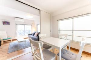 a living room with a white table and chairs at Apartment in Akihabara Station 3 minutes away, near Tokyo Staフリ in Tokyo