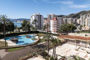 a resort with a pool and palm trees and buildings at Florazar 2, Vi-5-B in Cullera