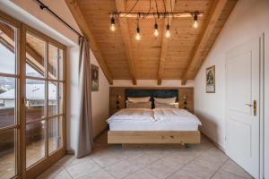 a bedroom with a bed and a wooden ceiling at Ferienhaus Die 12 mit 4 Schlafzimmern in Garmisch in Garmisch-Partenkirchen