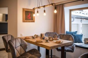 a dining room table with chairs and a table at Ferienhaus Die 12 mit 4 Schlafzimmern in Garmisch in Garmisch-Partenkirchen