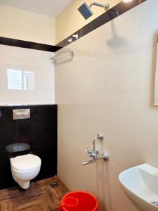 a bathroom with a toilet and a sink at Hotel Jeyam in Kanyakumari