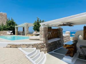 a villa with a swimming pool and a pavilion at Milo Milo Suites in Mandrakia