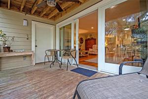 a screened porch with a table and chairs on it at 6A Seagrove Villa in Isle of Palms