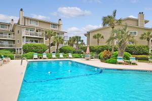 a swimming pool in front of a building with a resort at 6A Seagrove Villa in Isle of Palms