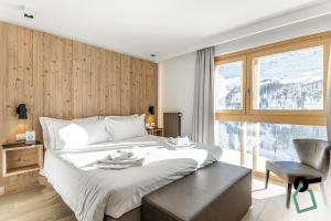 Postel nebo postele na pokoji v ubytování HOTIDAY Room Collection - Cervinia