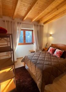 a bedroom with a bed and a wooden ceiling at Casa da Quinta Costa D'Além Gerês in Terras de Bouro