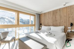 Postel nebo postele na pokoji v ubytování HOTIDAY Room Collection - Cervinia