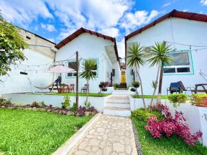a house with a garden and a pathway at NEW YORK by luxury atitlan in San Pedro La Laguna