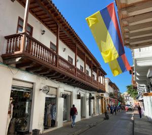 a flag hanging on the side of a building on a street at Hotel Casa Agustina in Cartagena de Indias