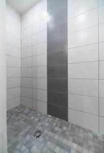 a bathroom with a shower with a tile floor at Le Darcet - Appartement Calme et lumineux in Vichy