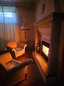a living room with a fireplace and a couch at La Veranda in Marradi