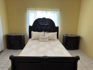 a bedroom with a large bed and two night stands at St Bess Comfort Style in Black River
