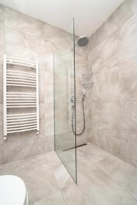 a bathroom with a glass shower with a toilet at Maldives Holiday Homes in Kyrenia
