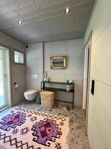 a bathroom with a tub and a sink and a toilet at Villa Blue Dream in Kristiansund