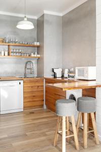 a kitchen with a counter and two stools at Silver Coast - Casa da Lagoa in Foz do Arelho